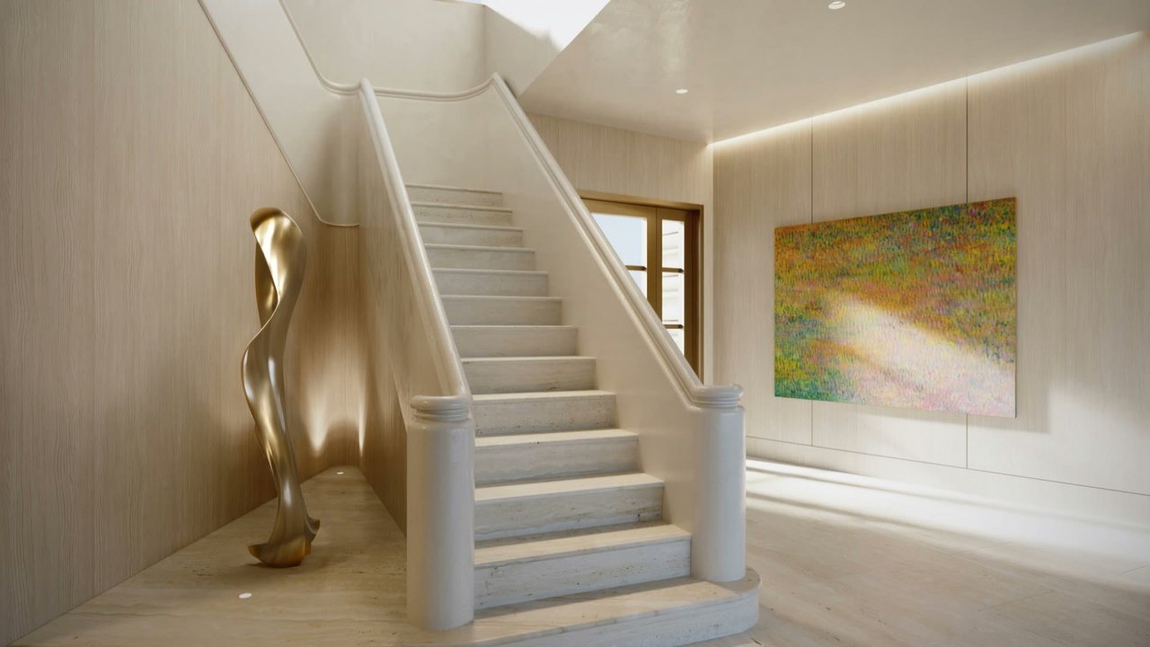 The foyer and the grand staircase rising to the upper floor.